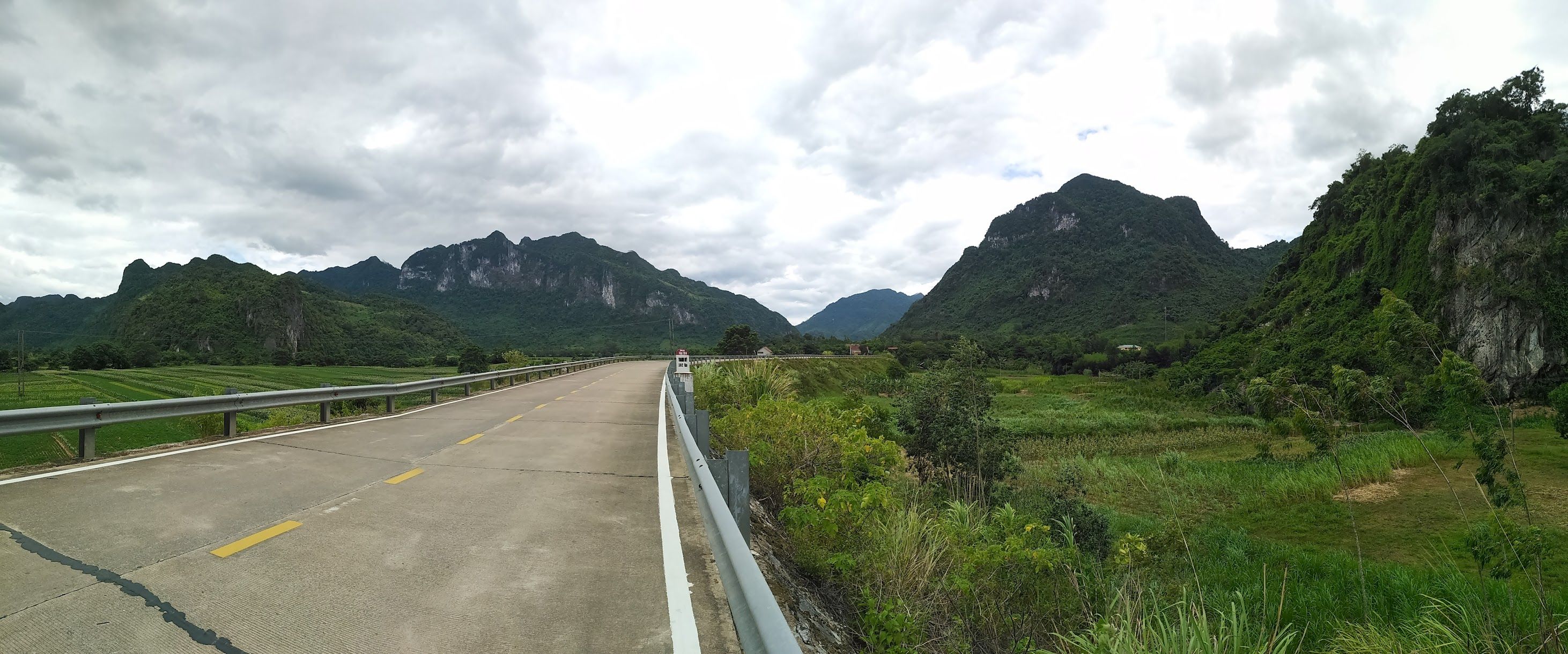 Driving down a long road through the Vietnamese mountains